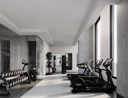 A gym with a variety of equipment and a view of the outside.