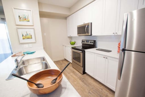 a kitchen with stainless steel appliances and white cabinets