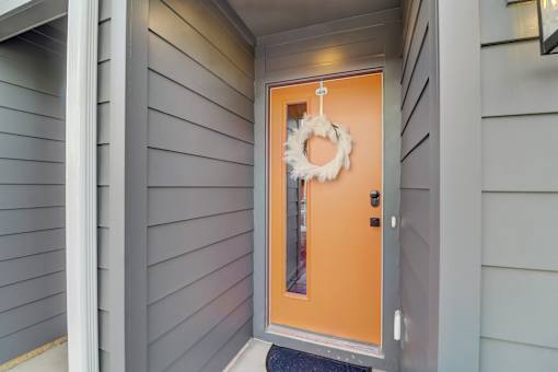 A door with a wreath on it is the main focus of the image.