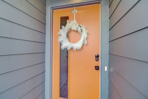 A door with a wreath on it.