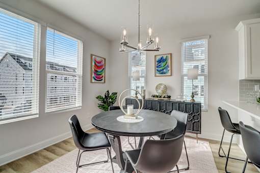 A dining room with a round table and chairs.