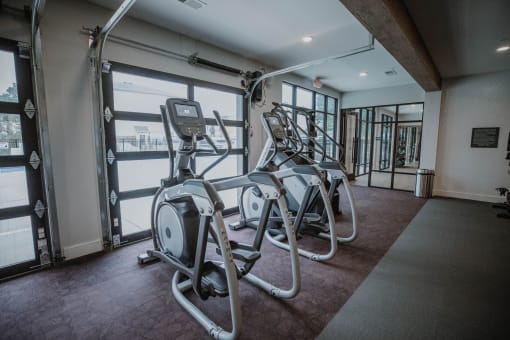 a gym with cardio equipment in a building
