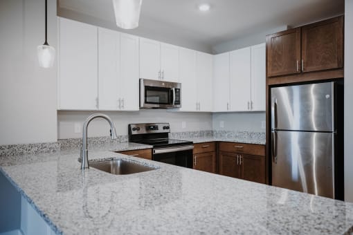 a kitchen with granite counter tops and stainless steel appliances