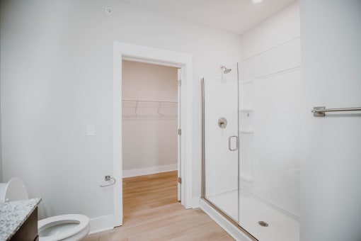 a bathroom with a glass shower and a toilet