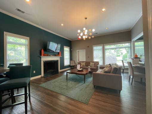 a living room with couches and chairs and a fireplace at Hidden Creek, Morrow, GA