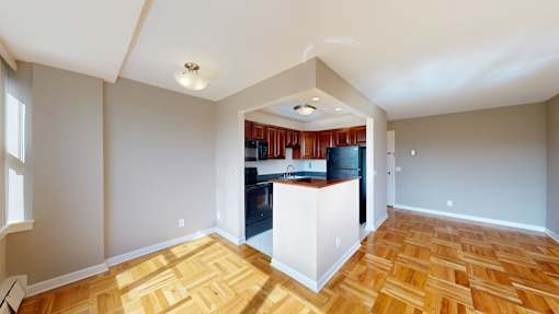 A kitchen with wooden floors and a white island.
