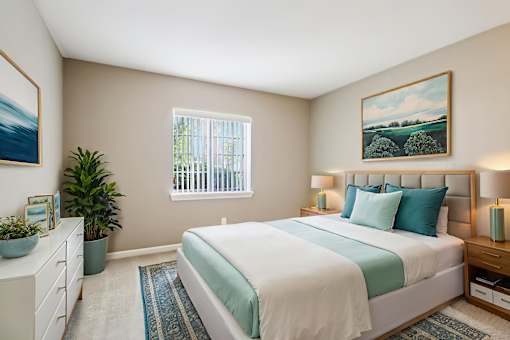 A bedroom with a large bed and a painting on the wall.
