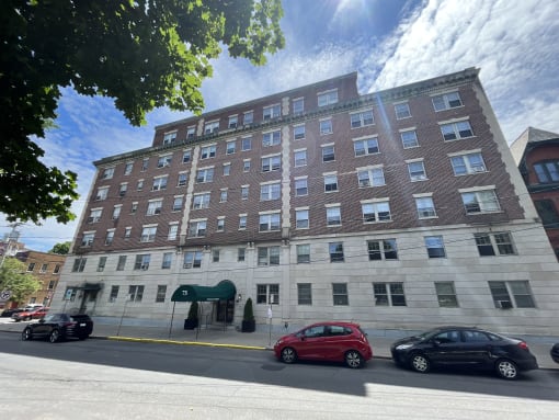 a large brick building with cars parked in front of it