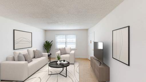 A living room with a white couch, a coffee table, a plant, and two framed artworks on the wall.