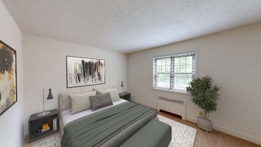 A bedroom with a large bed and a painting on the wall.