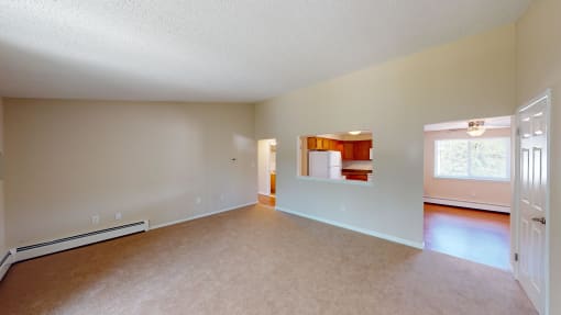 the living room and dining room of an empty house