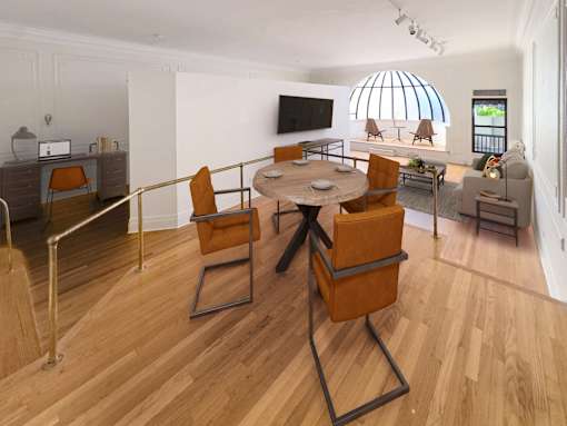 A living room with a TV, chairs, and a table.