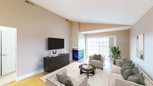 A living room with a flat screen TV and a coffee table.