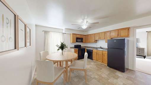 A kitchen with a table and chairs in the middle of the room.