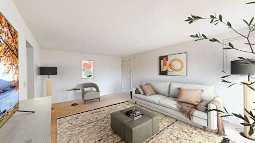 A living room with a white couch and a coffee table.