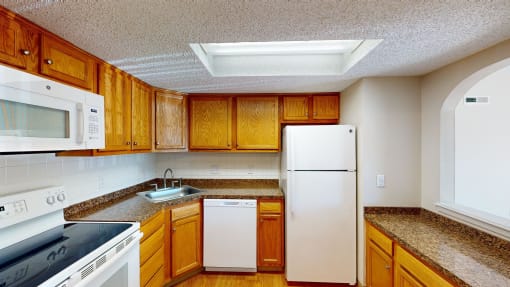 a kitchen with wooden cabinets and a white refrigerator