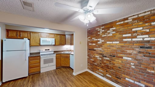 a kitchen with a brick wall and white appliances