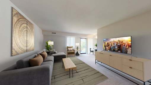 A modern living room with a grey sofa, a wooden coffee table, and a large flat-screen TV.