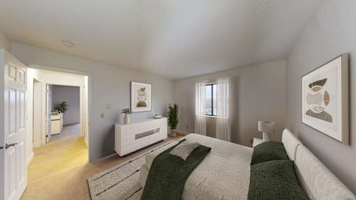 A bedroom with a bed, nightstand, and a plant.