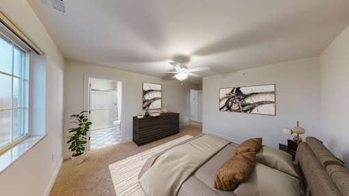 A living room with a couch, a rug, and a painting on the wall.