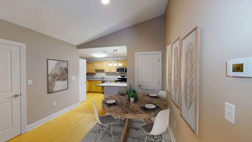 A dining room with a table and chairs is shown.