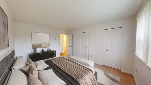 a bedroom with a bed and a dresser and a door to a bathroom