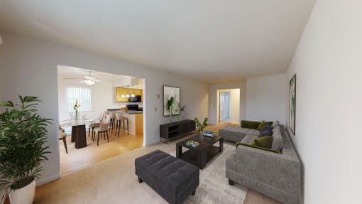 a living room with a couch and a chair and a dining room and a kitchen