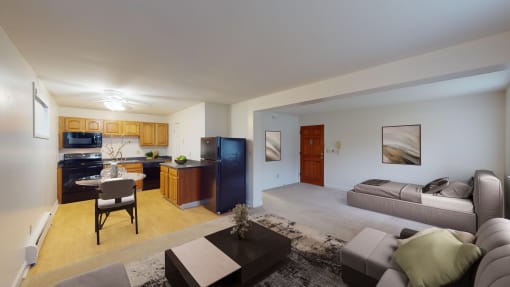 a living room and kitchen with a couch and a table