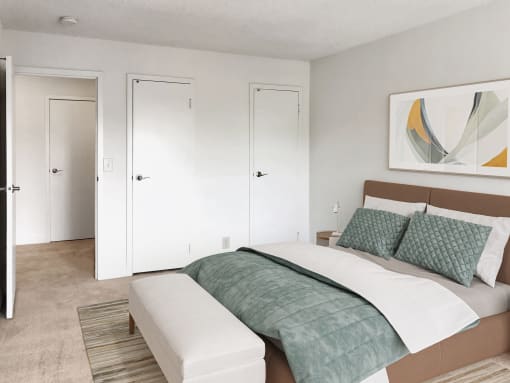 a bedroom with white walls and a bed with green pillows