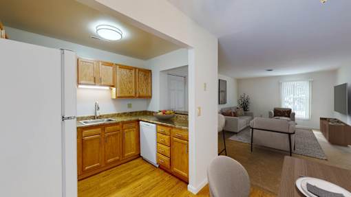 A kitchen with wooden cabinets and a white refrigerator.