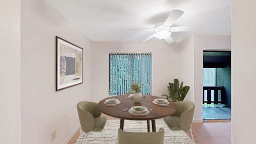 A dining room with a table set for four.