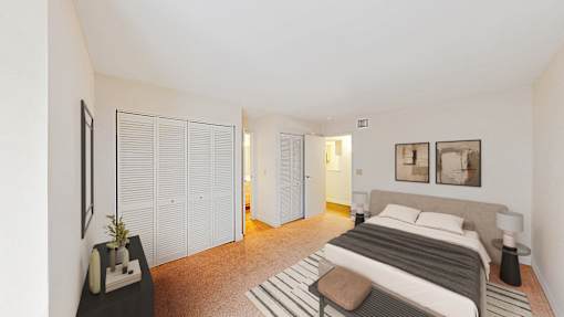 A bedroom with a bed, nightstand, and a plant on a table.