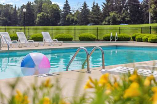 A pool with a blue and pink ball in the middle of it.