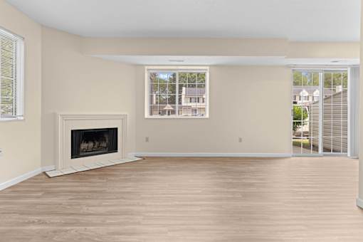 A room with a fireplace and sliding glass doors.