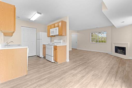 A kitchen with wooden cabinets and a white fridge.