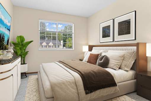 A bedroom with a large bed and a potted plant.
