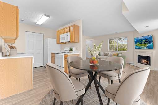A modern kitchen with a dining table set for four.