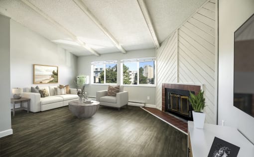 a living room with white furniture and a fireplace