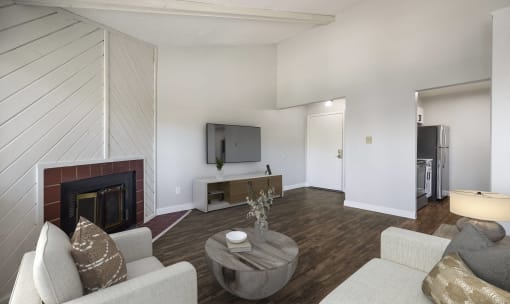 a living room with a fireplace and a tv