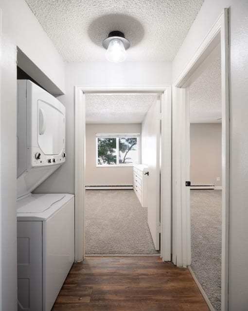 an empty laundry room with a washer and dryer