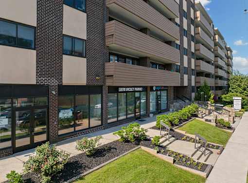 A modern building with a garden in front.