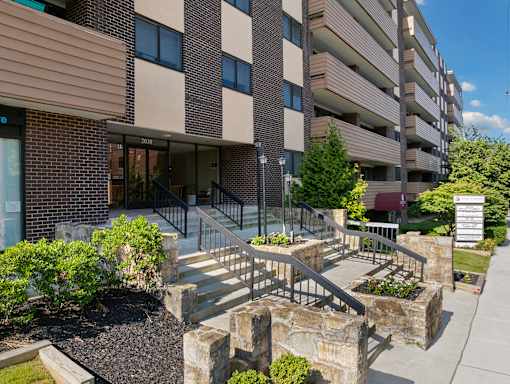 Front entrance and retail space of Lafayette Towers apartment building