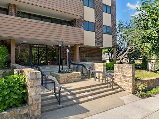 A building with a stone wall and a metal railing.