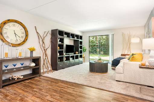 A living room with a large clock on the wall.