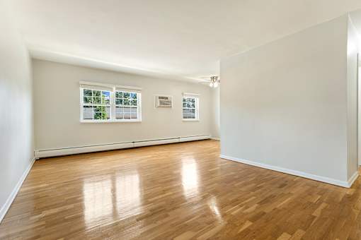 A room with wooden floors and white walls.