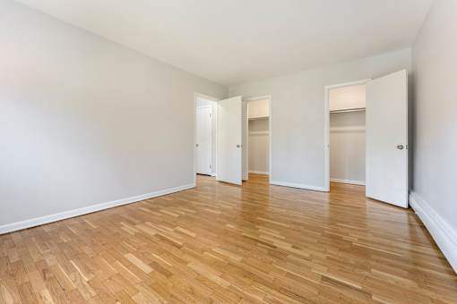 A room with wooden floors and white walls.