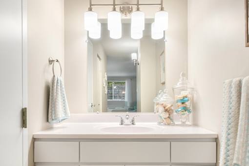 Well-lit vanities with extra cabinet storage in every apartment.