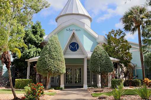 A white building with a blue roof and a sign that says "Marson".