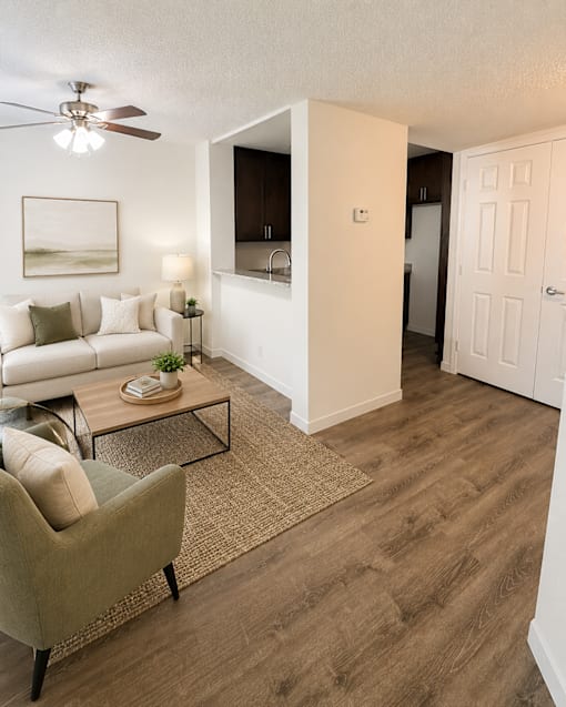 A living room with a white couch and a coffee table.