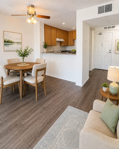 A living room with a dining table and chairs.